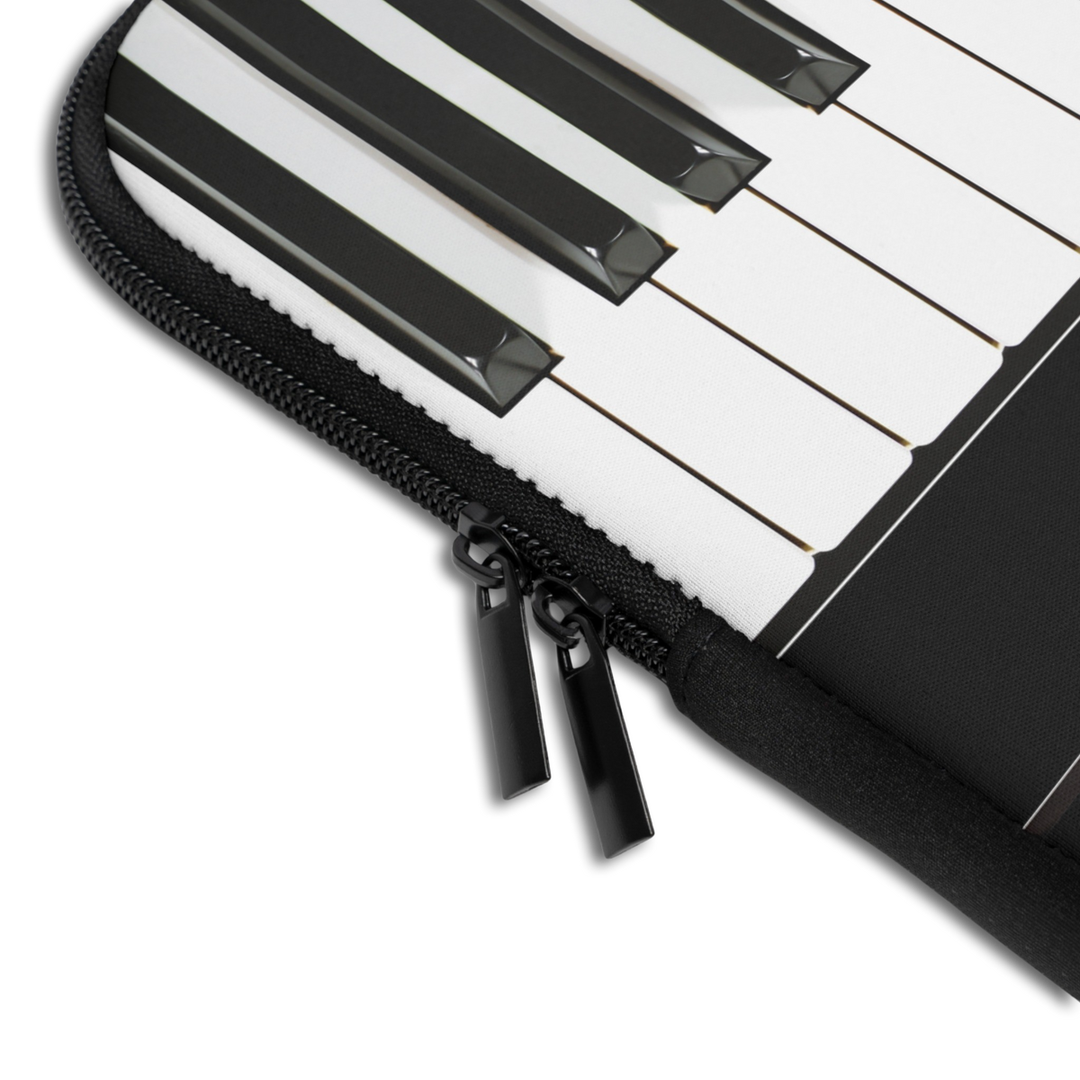 Close-up of the Personalized Piano Keys Laptop Sleeve sleeve corner showing the printed design, the padded edge and the dual zipper pulls